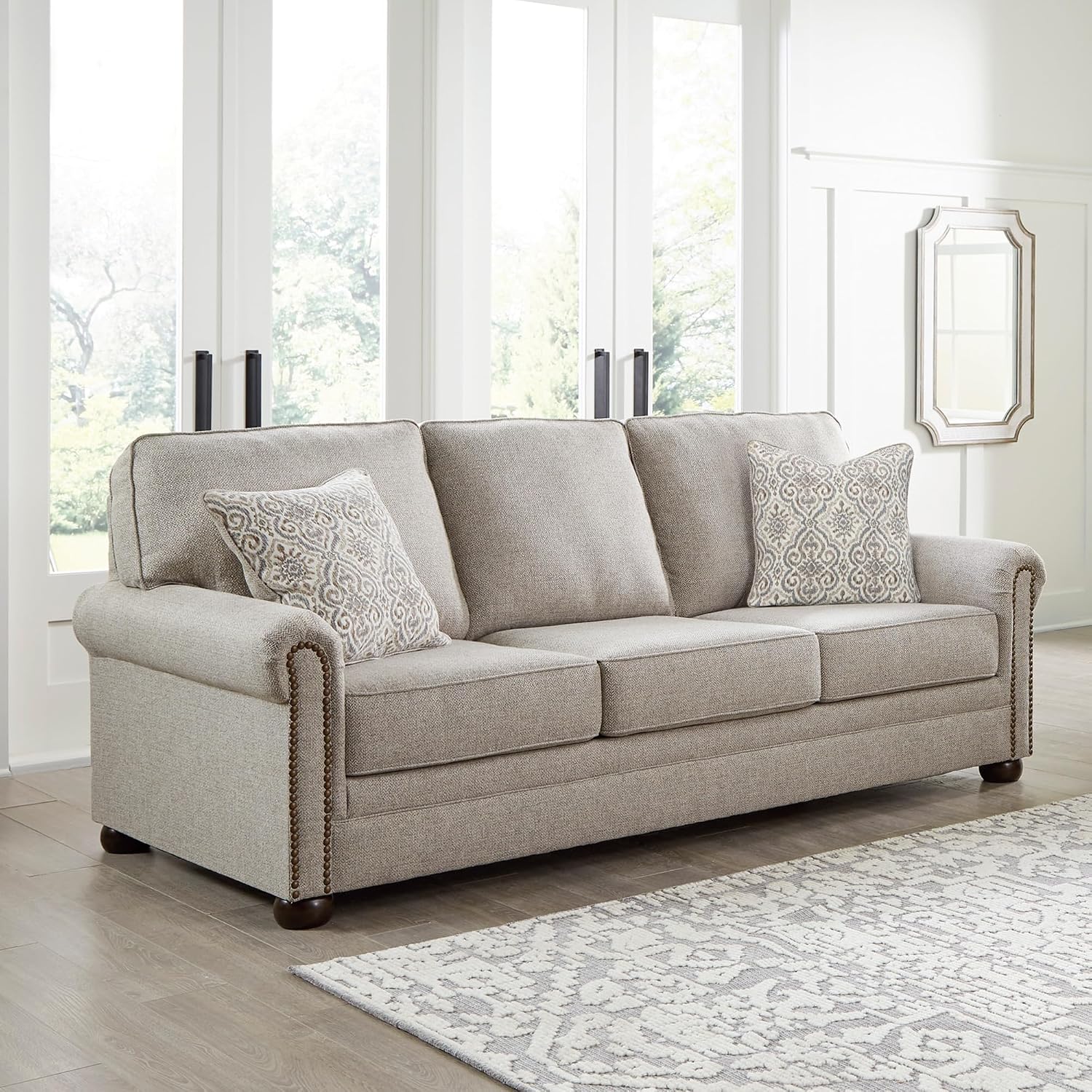 Signature Design by Ashley Gaelon Transitional Sofa with Nailheads and 2 Accent Pillows, Beige